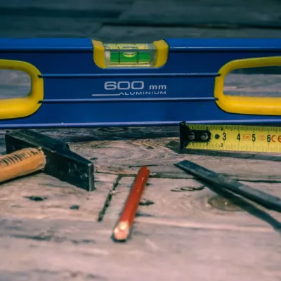 orange pen beside blue tape dispenser