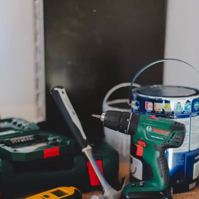 red and black cordless power drill beside black and red cordless power drill